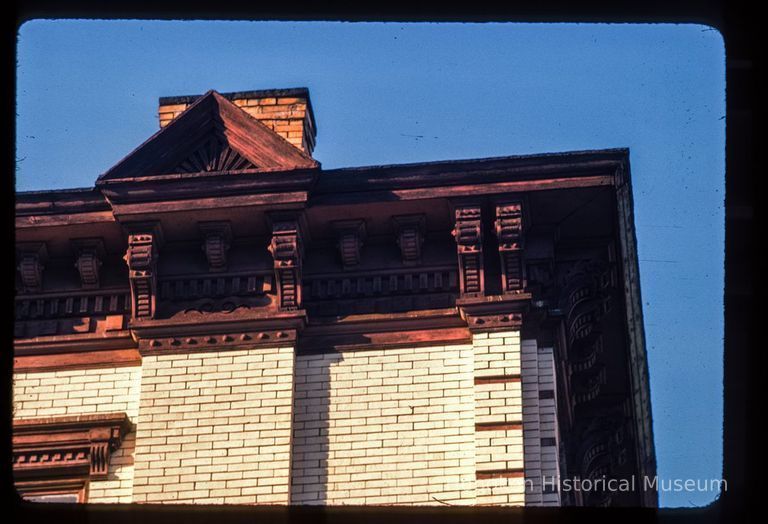 Color slide of detail view of chimney, pediment, cornice, brackets, window head and brick quoins at an unidentified location picture number 1