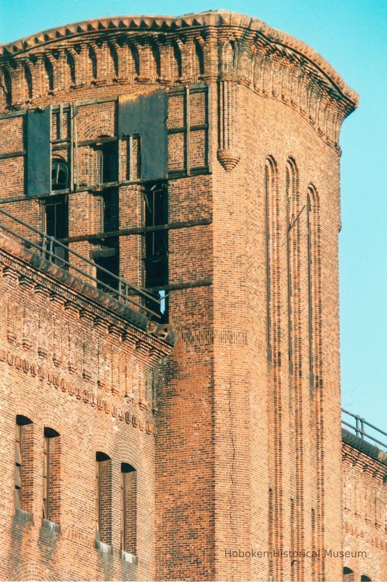 Digital image of color photo of an exterior detail of tower top at the former Hudson & Manhattan Rail Road powerhouse, Jersey City, Oct., 199 picture number 1