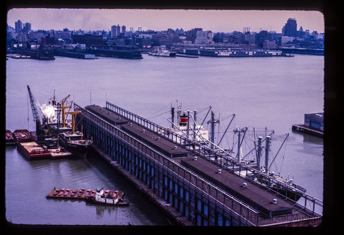 Color slide of aerial view from River & 3rd looking E at Pier B with the New York City skyline across the Hudson River picture number 1