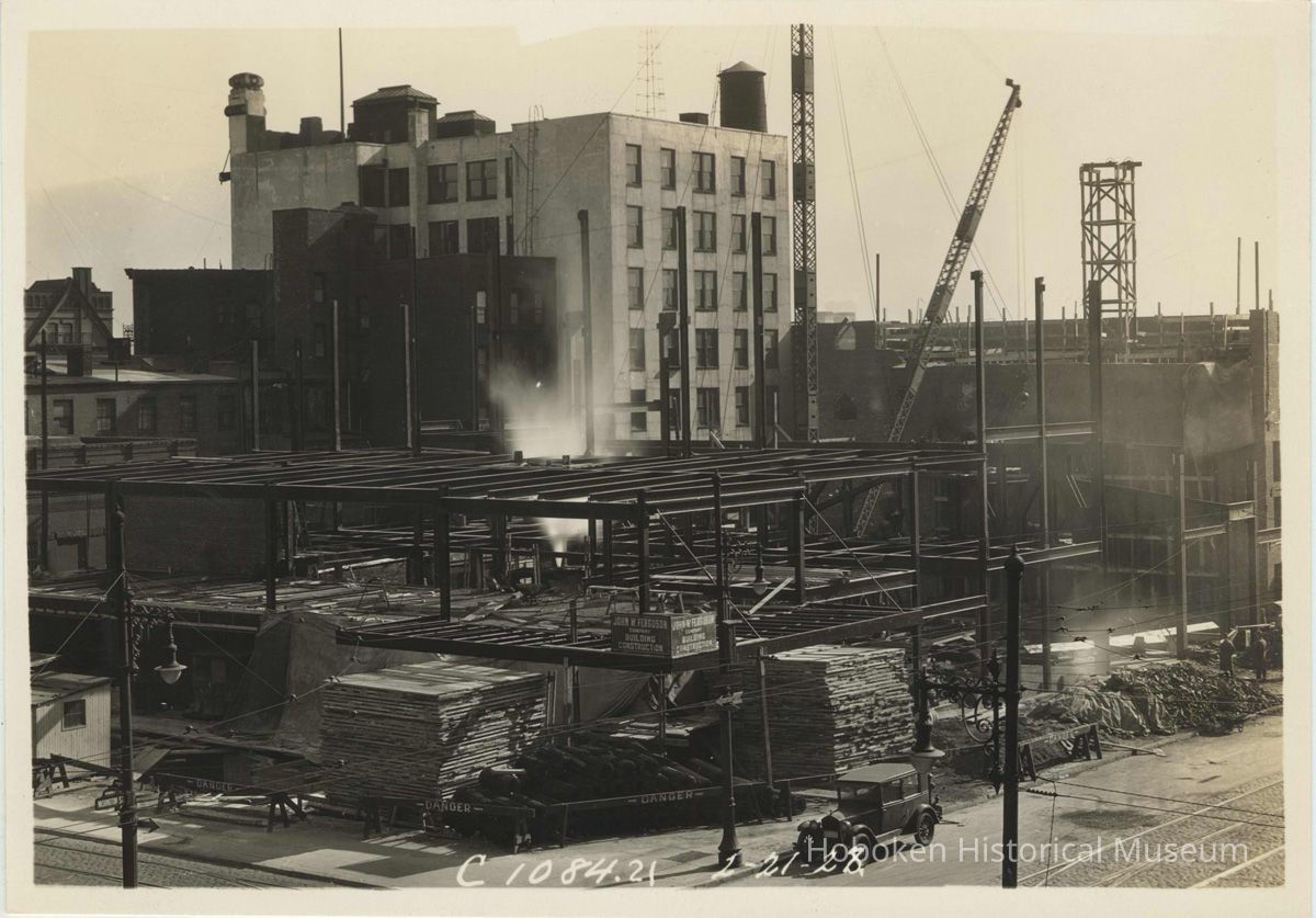 Sepia-tone photo of steel frame erection on the site for the Fabian Theatre, southeast corner of Newark & Washington Sts., Hoboken, Feb.21, 1928. picture number 1