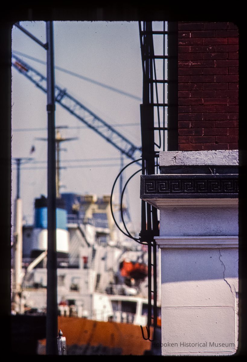 Color slide of detail view of frieze and fire escape at 1321 Washington on the SE corner with 14th looking E and a ship docked at the foot of 14th picture number 1