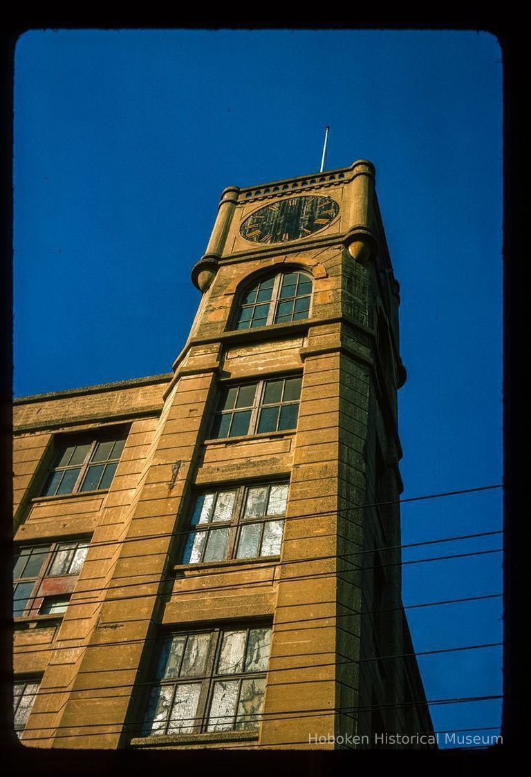 Color slide of close-up view of the clock tower at 300 Adams on the NW corner with 3rd formerly the Keuffel and Esser Manufacturing Complex picture number 1