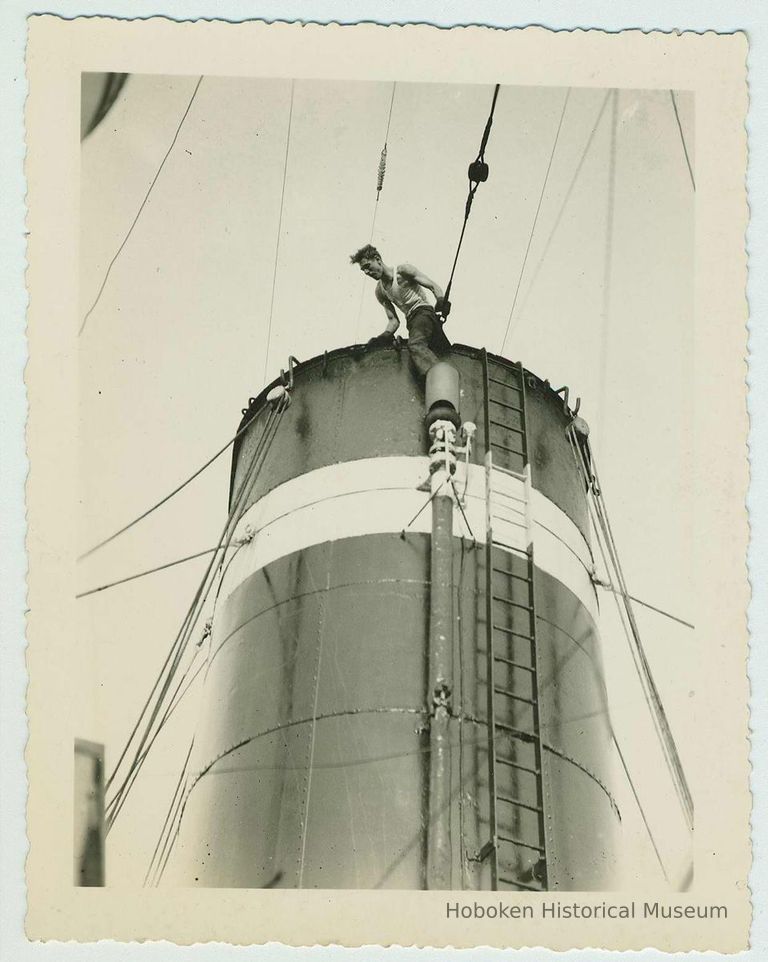 B+W photo of a shipyard worker near the top of a funnel on an unidentified vessel, no date, ca. 1940. picture number 1