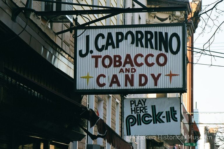 Color photo of hanging sign for J. Caporrino, Tobacco and Candy, 528 Adams St., Hoboken, Jan. 3 & 4, 2002. picture number 1