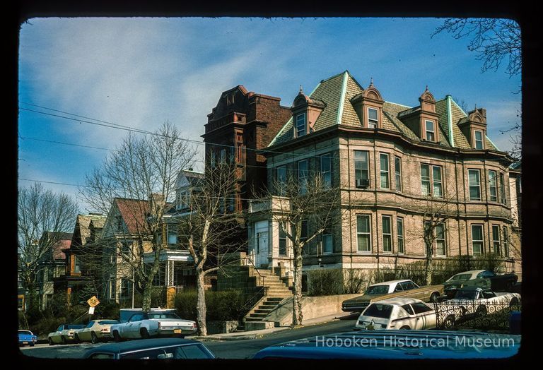 Color slide of eye-level view of front and side facades showing gable dormers and mansard roof at 901 Castle Point Terrace on the NE corner of 9th picture number 1