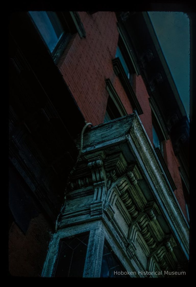 Color slide of detail view of façade, cornice and brackets on a building on Washington between 6th and 7th picture number 1