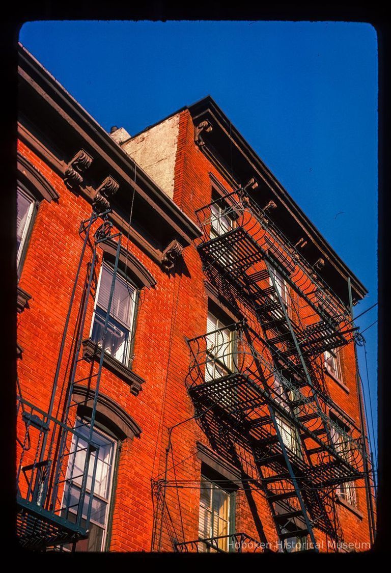 Color slide of detail view of row house façades, cornices and fire escapes on buildings at an unidentified location picture number 1