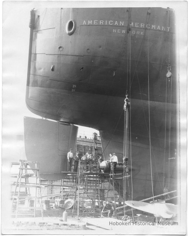 B+W photo of shipyard workers repairing the propeller of the S.S. American Merchant in dry dock, Hoboken, no date, ca. 1940. picture number 1