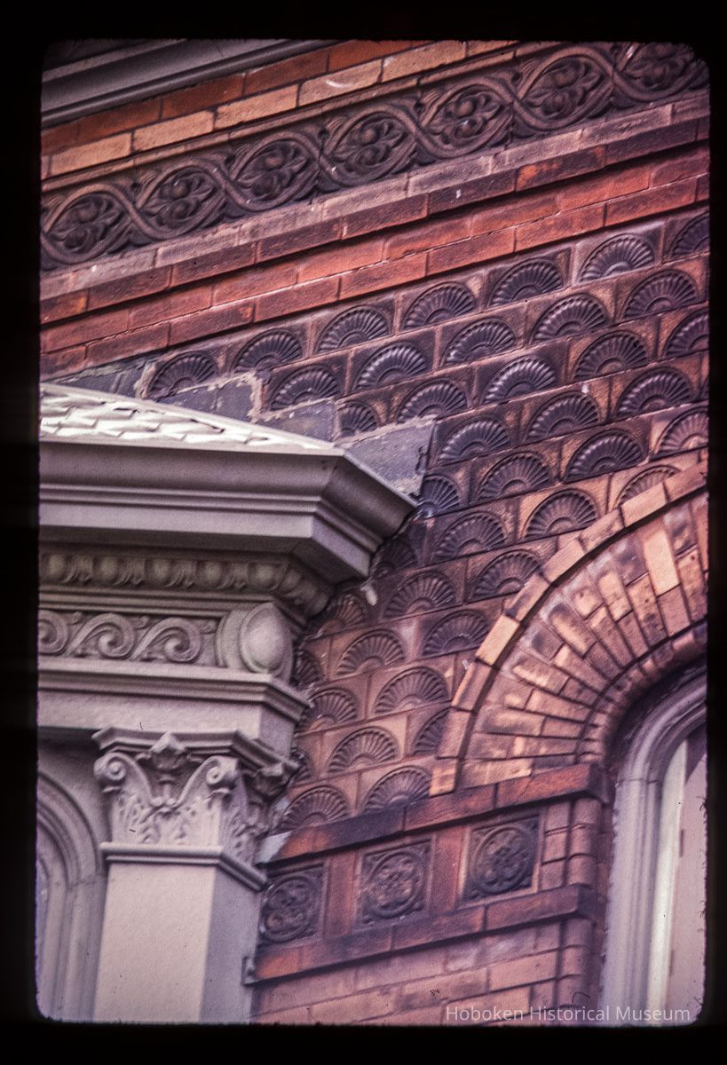 Color slide of detail view of portico semicircular arch, decorative tiles, and frieze at 105 4th between Washington and Bloomfield picture number 1