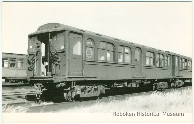 Digital image of Hudson & Manhattan R.R. photo postcard of motorized unit no. 266 at Meadows Car Shop, Oct. 12, 1958. picture number 1