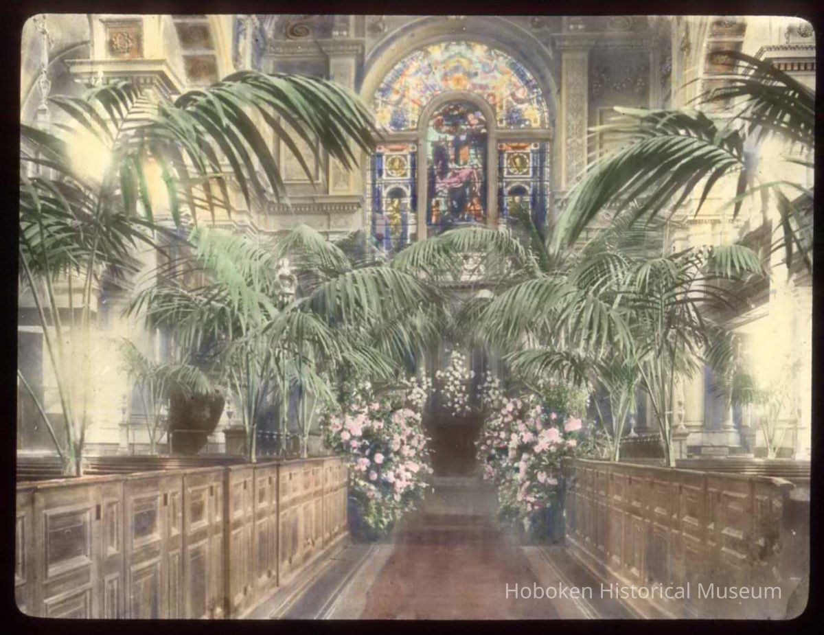 Lantern slide, color, of a church interior with floral decorations, used for promotional display in Hoboken, no date, ca. 1920. picture number 1