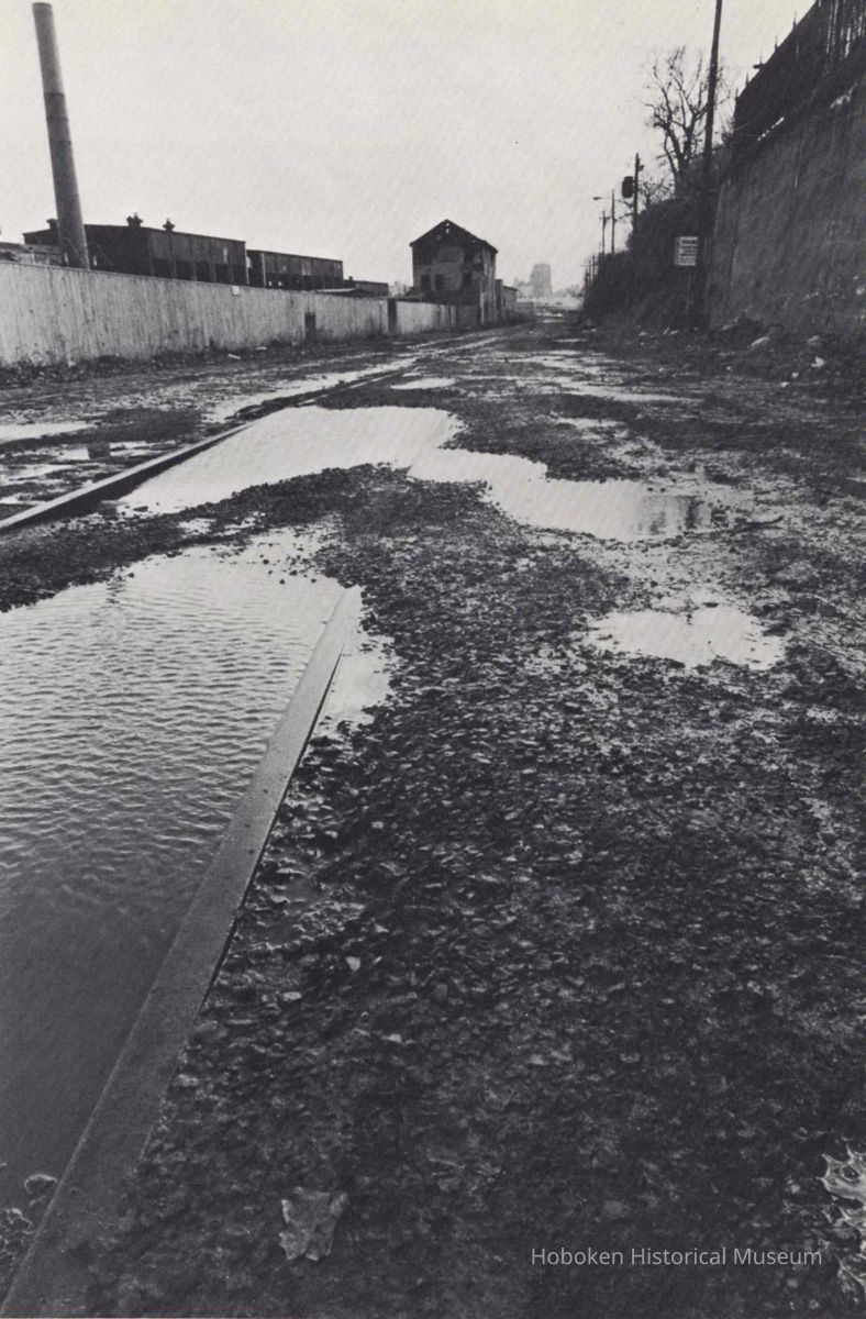 Reference image of printed photo image of Hoboken Shore Railroad right-of-way & track from pg 33 of archives catalog 2002.026.0002, Hoboken, ca. 1975. picture number 1
