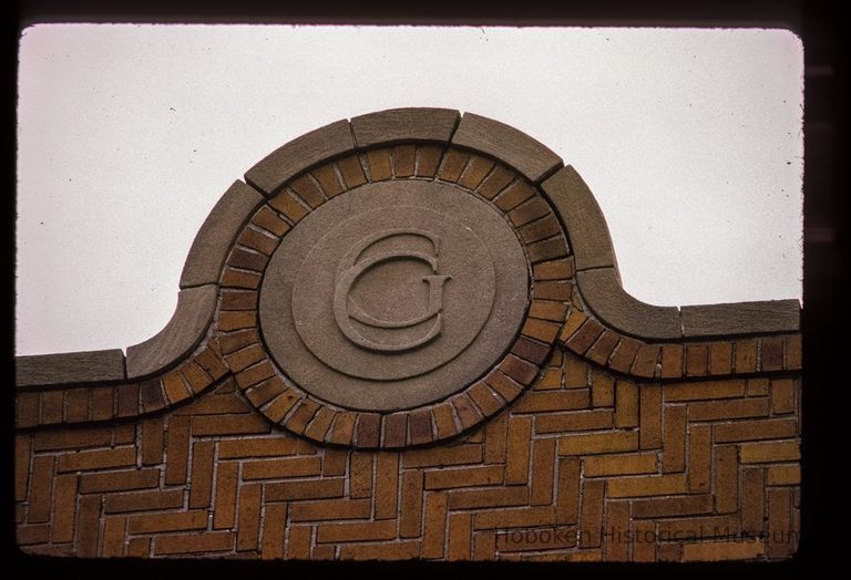 Color slide of close-up view of brick pediment reading 