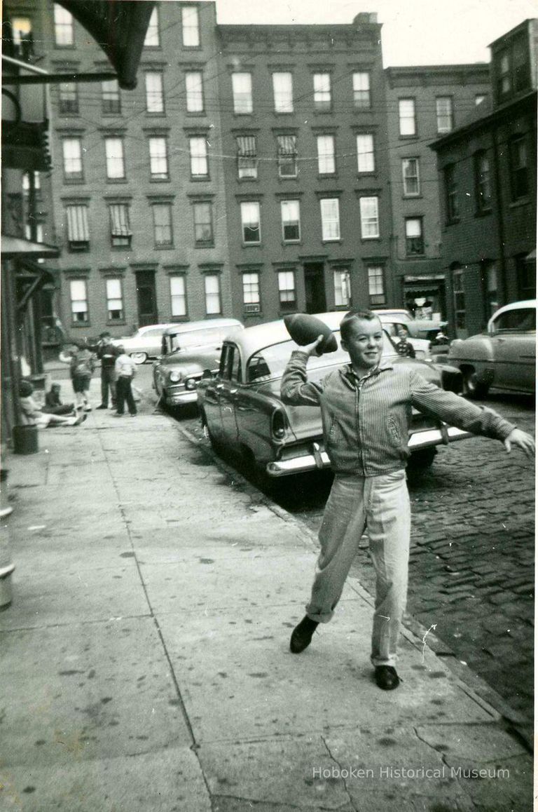 Tommy Duff  (of No. 26 Willow Terrace S.) throwing football, Willow Terrace