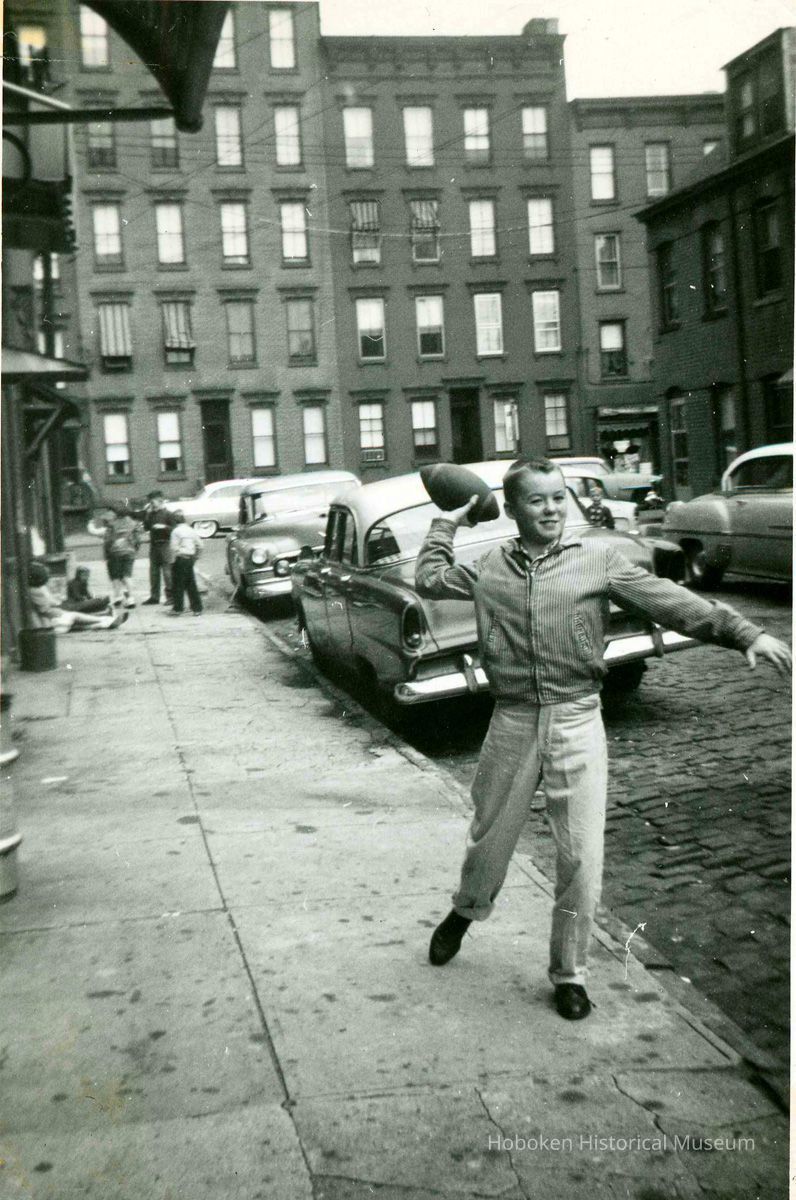 Tommy Duff  (of No. 26 Willow Terrace S.) throwing football, Willow Terrace