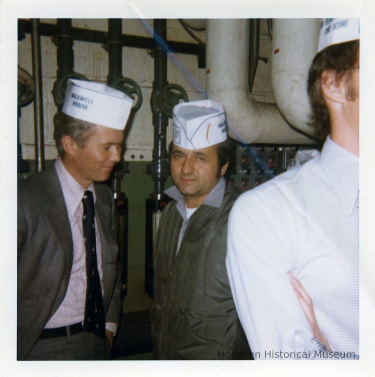 view inside Maxwell House Coffee plant; wearing paper hats