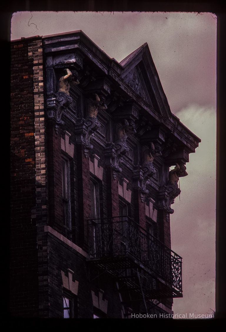 Color slide of close-up view of cornice, pediment, figurine brackets and fire escape at 712 Adams between 7th and 8th picture number 1