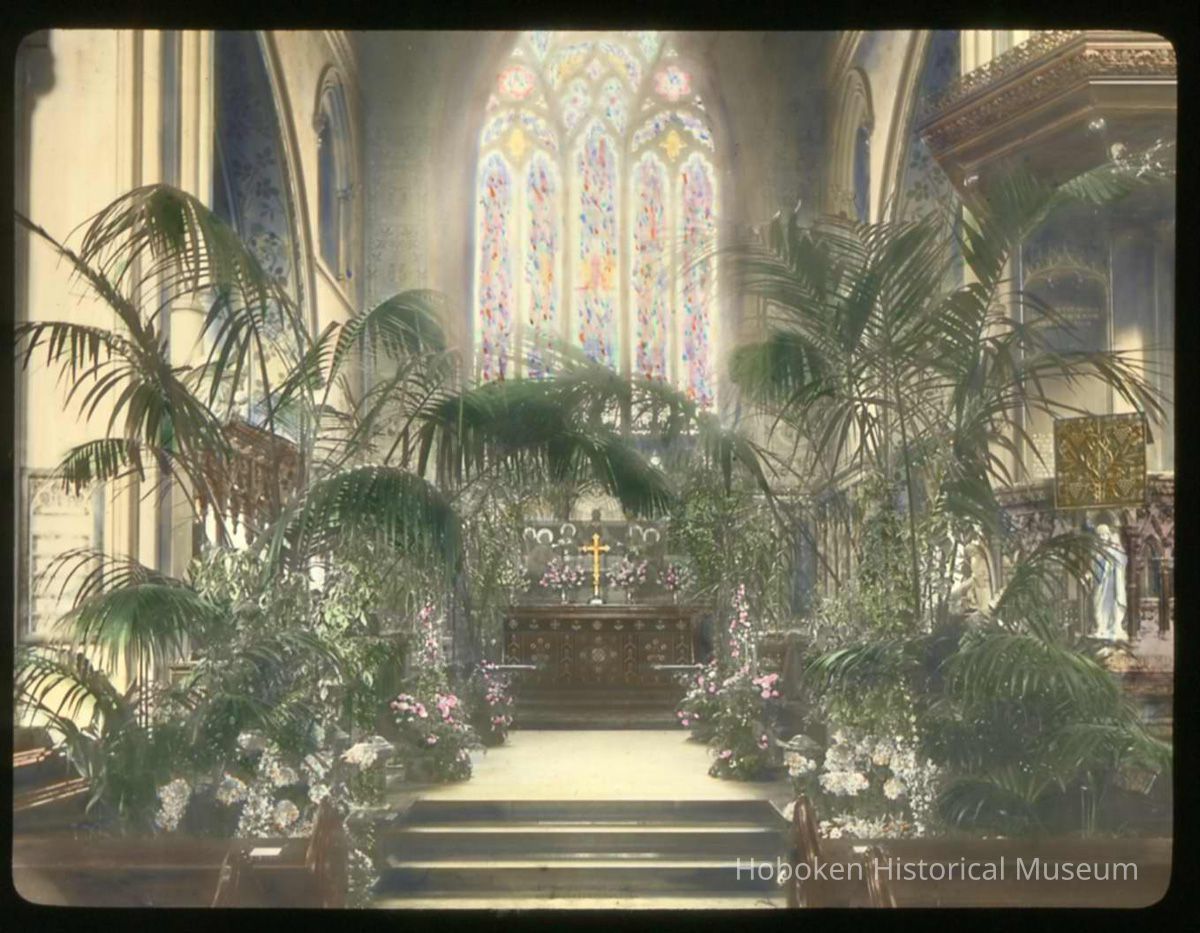 Lantern slide, color, of a church interior with floral decorations, used for promotional display in Hoboken, no date, ca. 1920. picture number 1