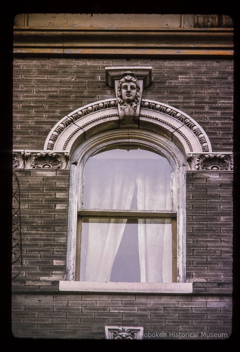 Color slide of close-up view of keystone, semicircular arch and decorative tile at 450 5th on the NW corner with Adams picture number 1