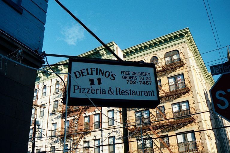 Color photo of hanging sign for Delfino's Pizzeria & Restaurant, corner of 5th & Jefferson Sts., Hoboken, Jan. 3 & 4, 2002. picture number 1