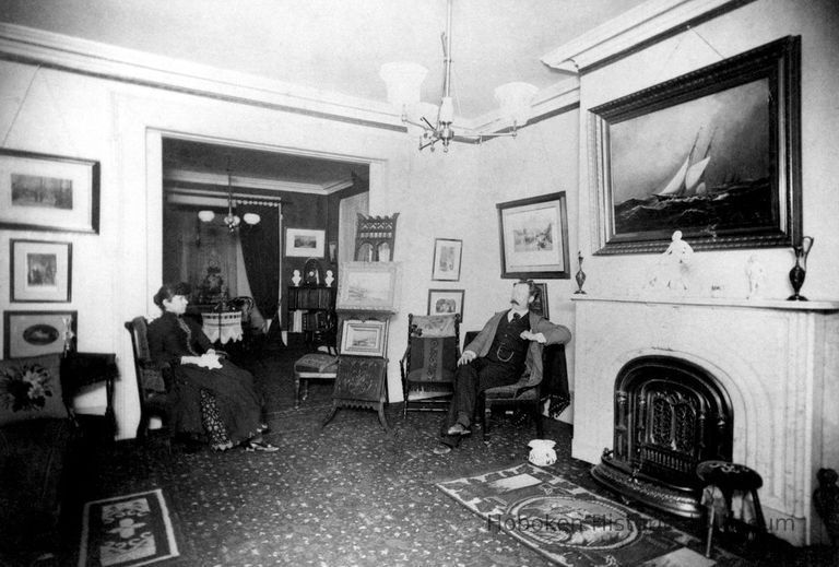 Digital black-and-white image of painter Antonio Jacobsen and wife Mary in their parlor, West Hoboken, no date, ca. 1890-1900. picture number 1