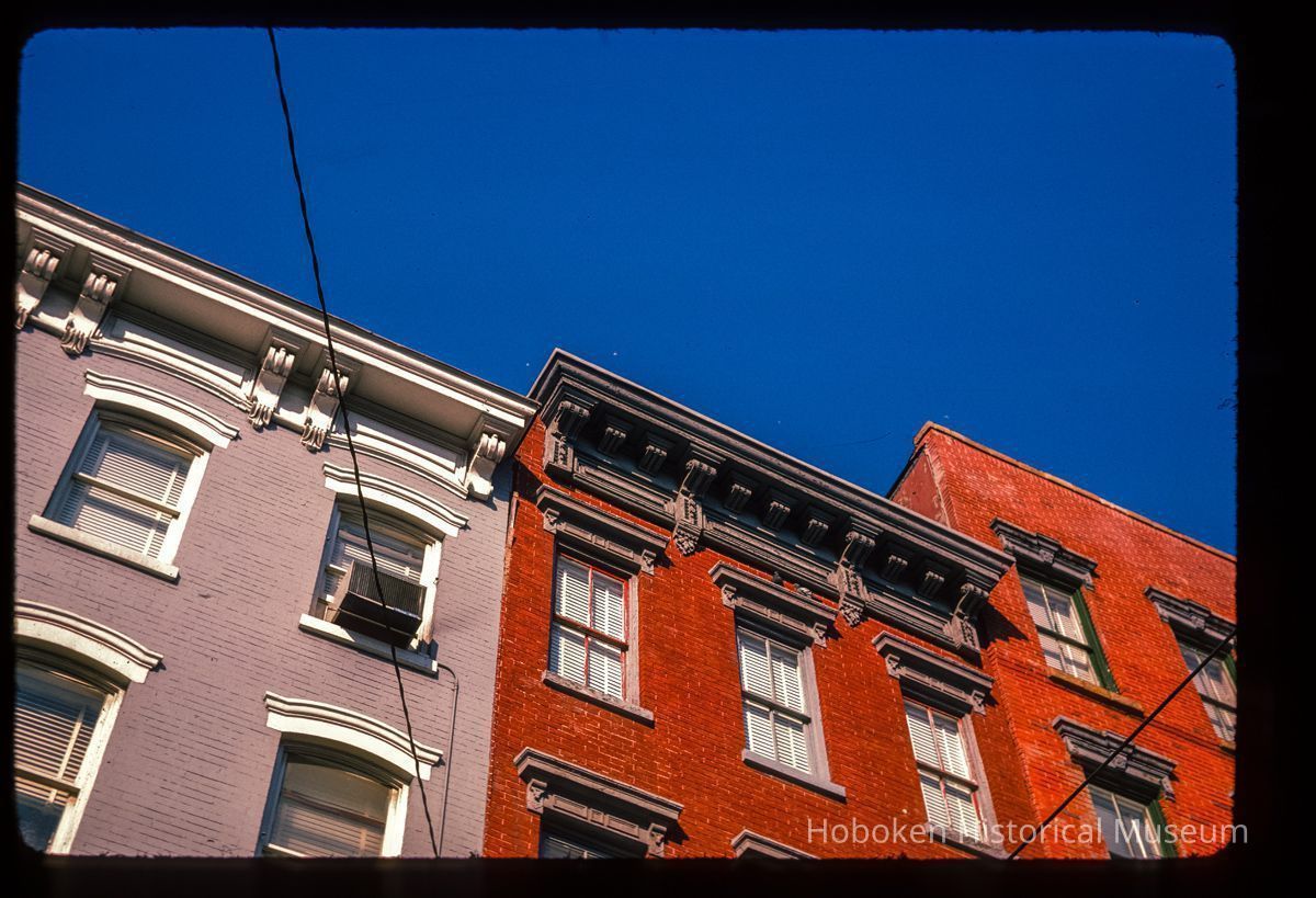 Color slide of close-up view of cornices, brackets, friezes and window heads on two buildings at an unidentified location picture number 1