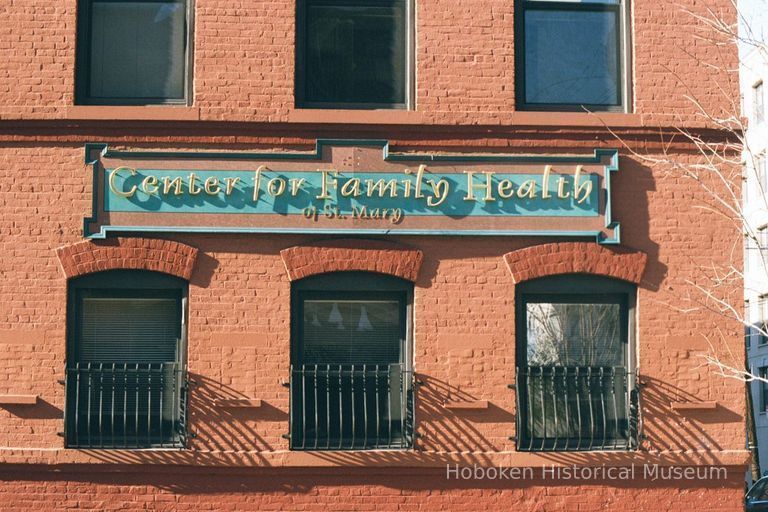 Color photo of a wall sign for Center for Family Health of St. Mary, 122-132 Clinton Street, Hoboken, Jan. 3 & 4, 2002. picture number 1