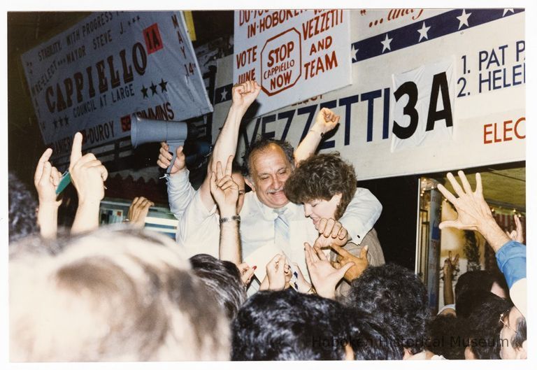 Color photo of mayoral candidate Tom Vezzetti with supporters in front of his campaign headquarters on election night, Hoboken, [June 11, 1985]. picture number 1