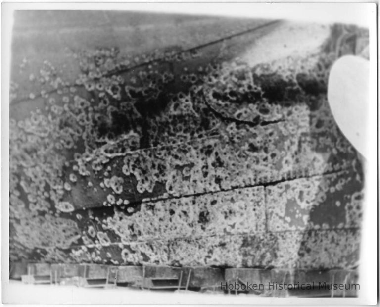 B+W photo near rudder of hull of unknown ship in drydock prior to scraping, Hoboken, no date, ca. 1940. picture number 1