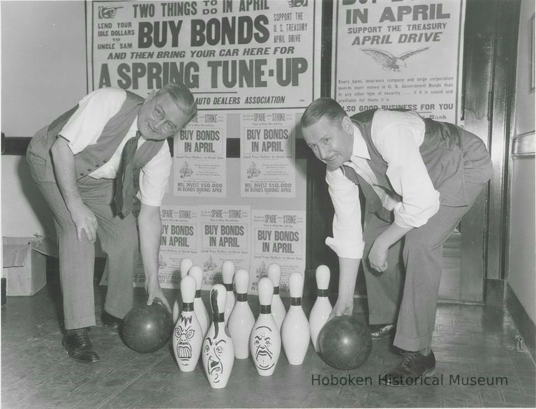 B+W photo of two Hudson County men at a bowling alley where caricatures of 