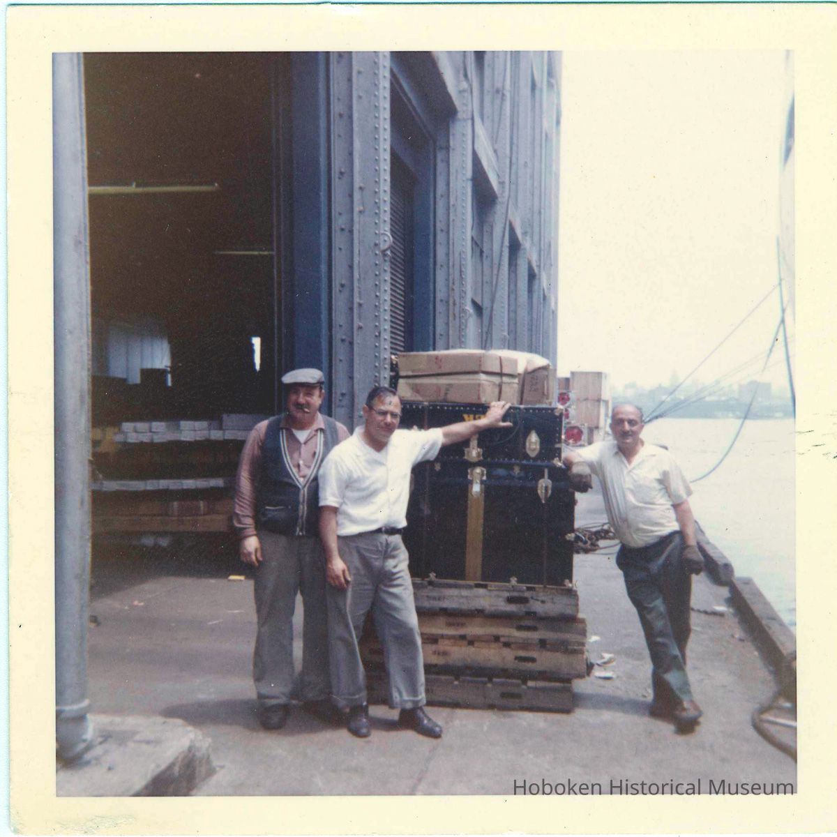 three longshoremen on pier