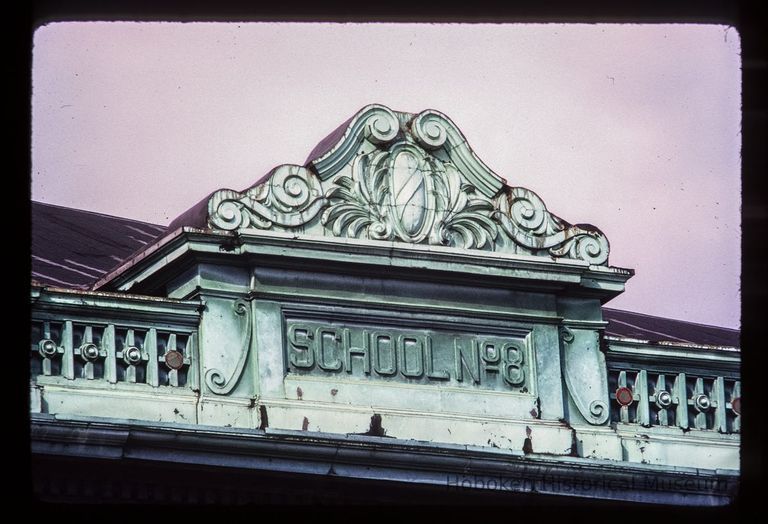 Color slide of close-up view of pediment and frieze reading 