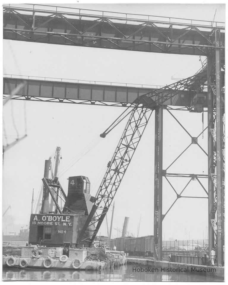 B+W photo of the barge derrick, A. O'Boyle No. 4, working on at the head of unidentified piers, location not known (Hoboken?), no date, ca. 1940. picture number 1