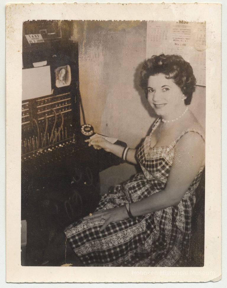 photo 1: Marie Feroldi at telephone switchboard.