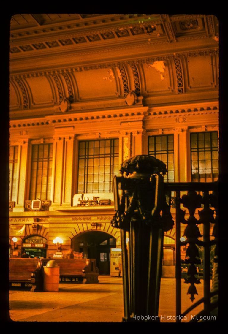 Color slide of interior eye-level view of Erie Railroad model train above the north door of the Lackawanna Terminal waiting room picture number 1