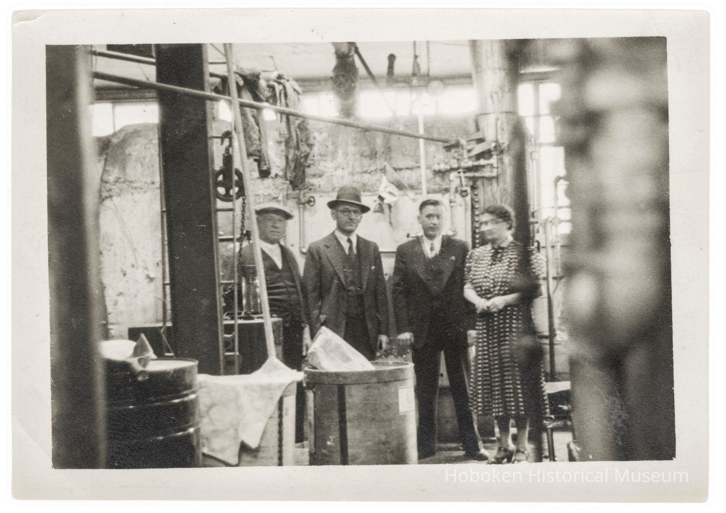 Photograph of Interior of the Hoboken Individual Laundry with four people picture number 1
