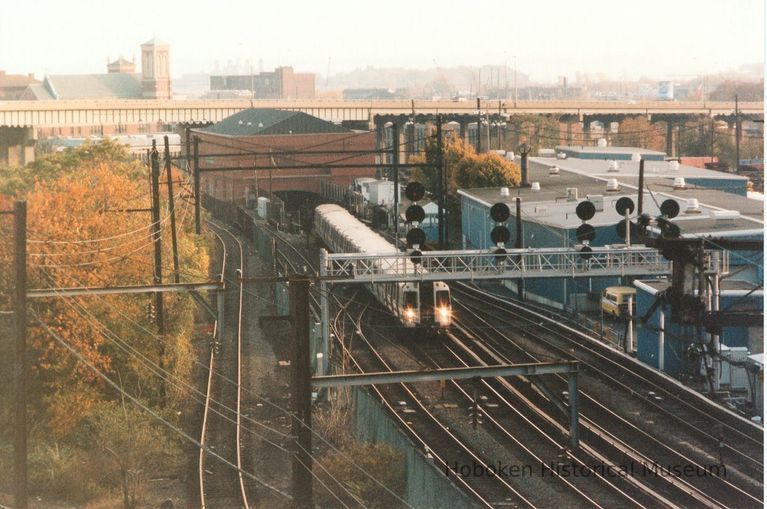 Digital image of color photo of a PATH train approaching Journal Square station from the east, Nov., 1999. picture number 1