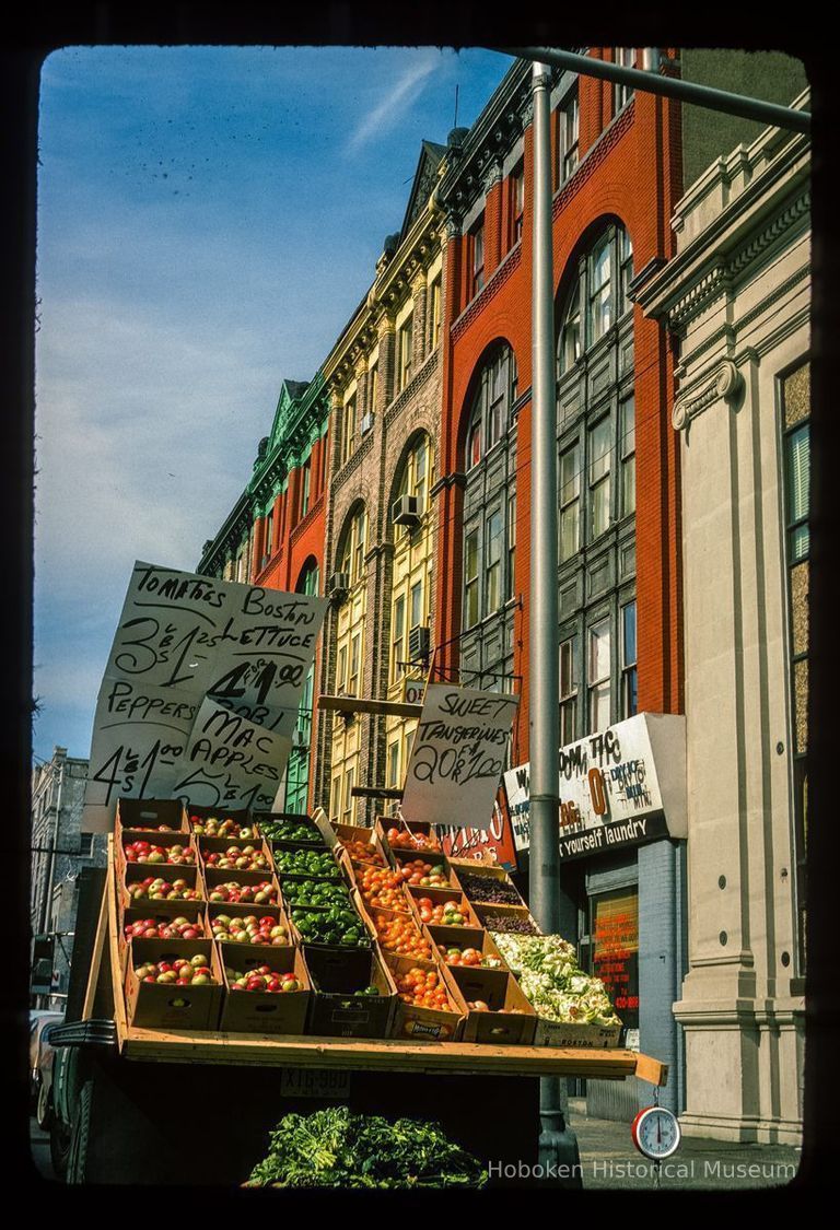 Color slide of eye-level view of produce truck on the NW corner of Washington & 14th and row houses along Washington looking W picture number 1