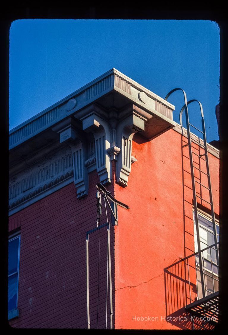 Color slide of detail view of cornice, brackets, frieze and fire escape at 155 6th between Bloomfield and Garden picture number 1