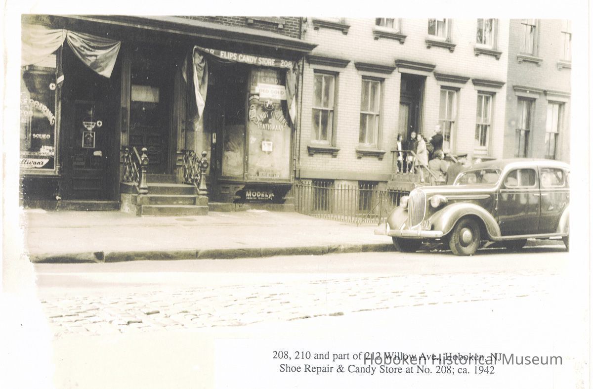Photo print: 208, 210 & part of 212 Willow Ave. Hoboken, NJ, Shoe Repair and Candy Store at No. 208; ca. 1942. picture number 1