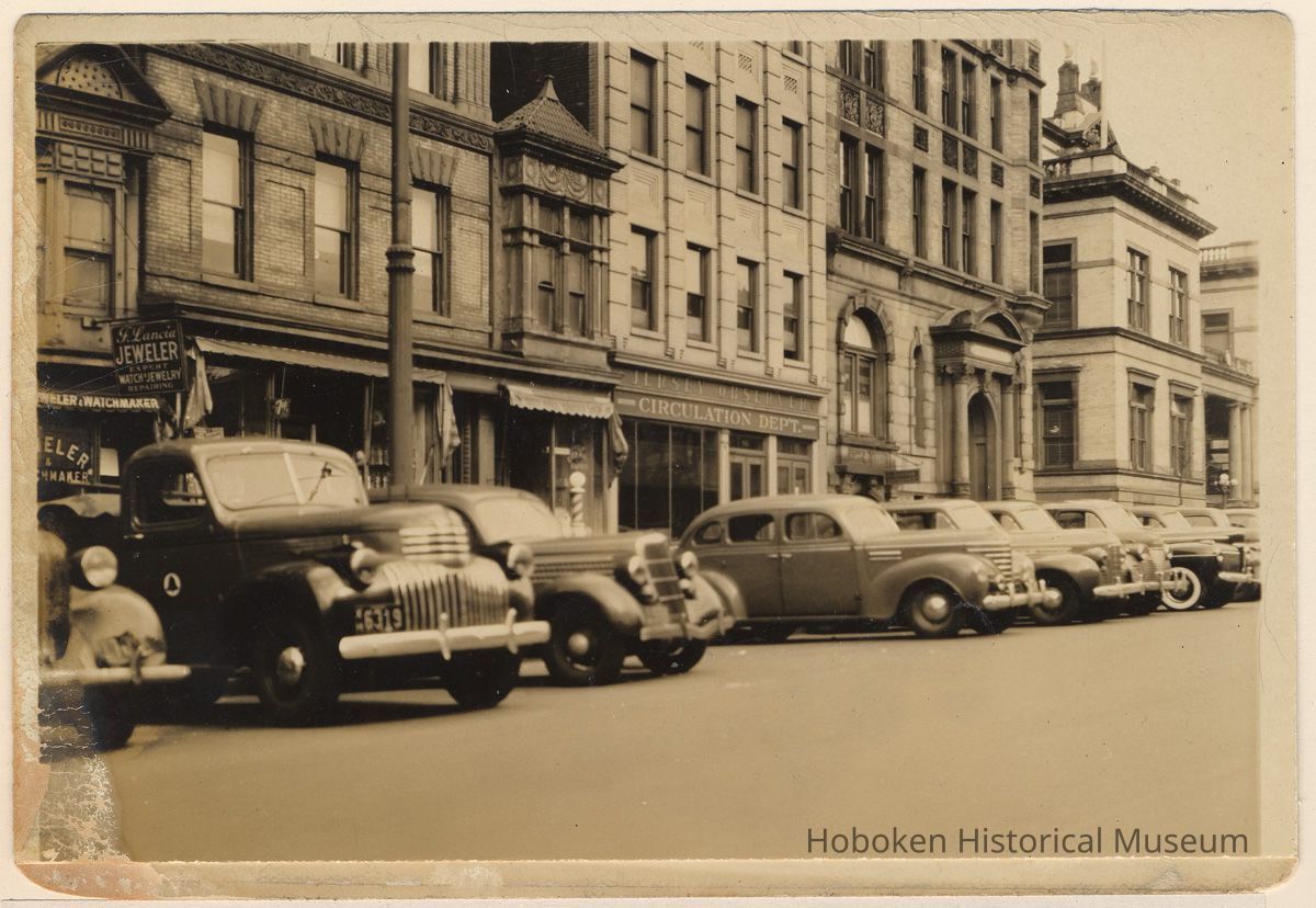 Washington St. looking north to Newark St., showing 74-76-78, 80 and 82-84 Washington St. & Hoboken City Hall, Hoboken, 1942. picture number 1