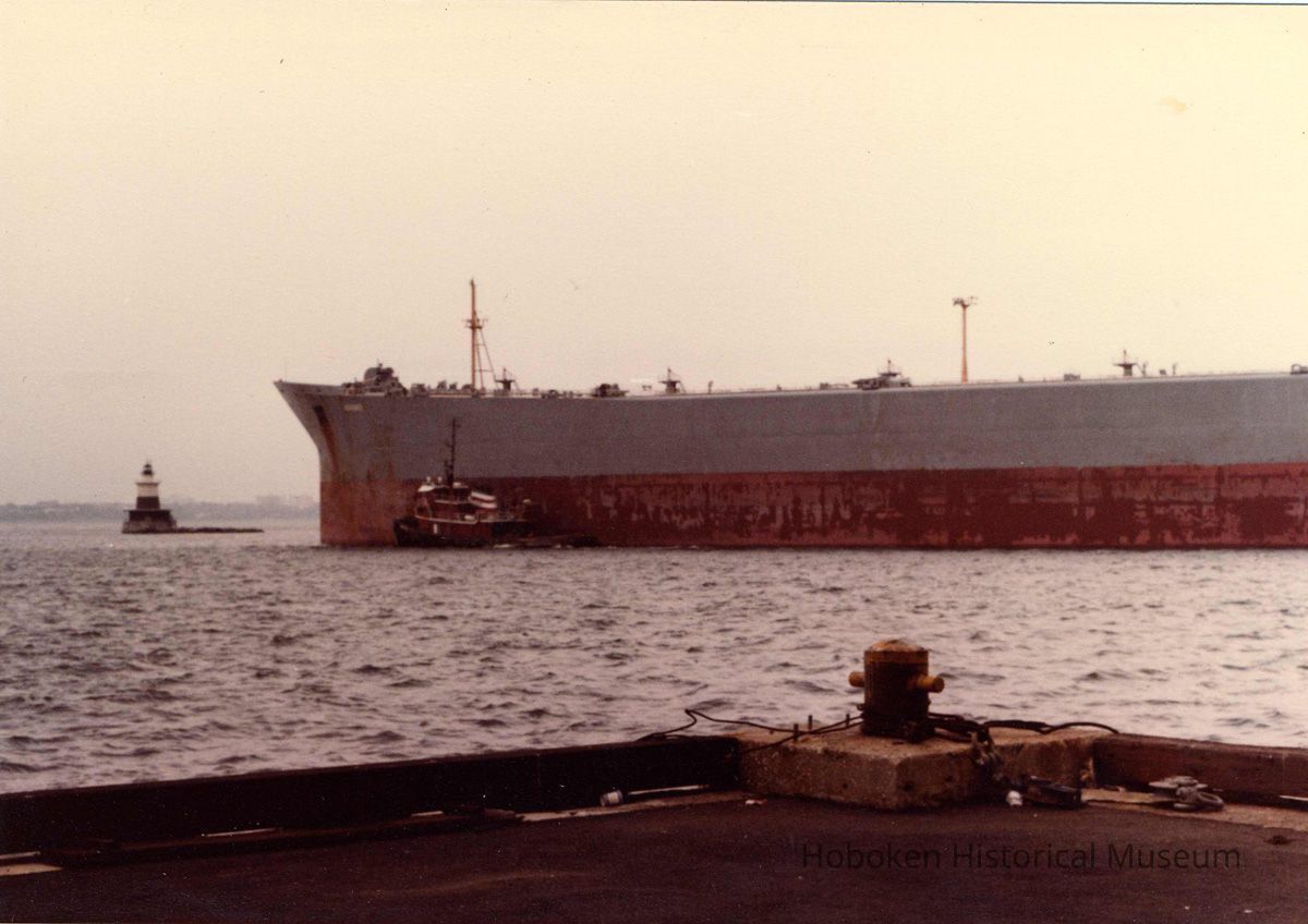 Digital scan of color photo of New York Harbor with a vessel and tugboat, no date, circa 1970-1980. picture number 1