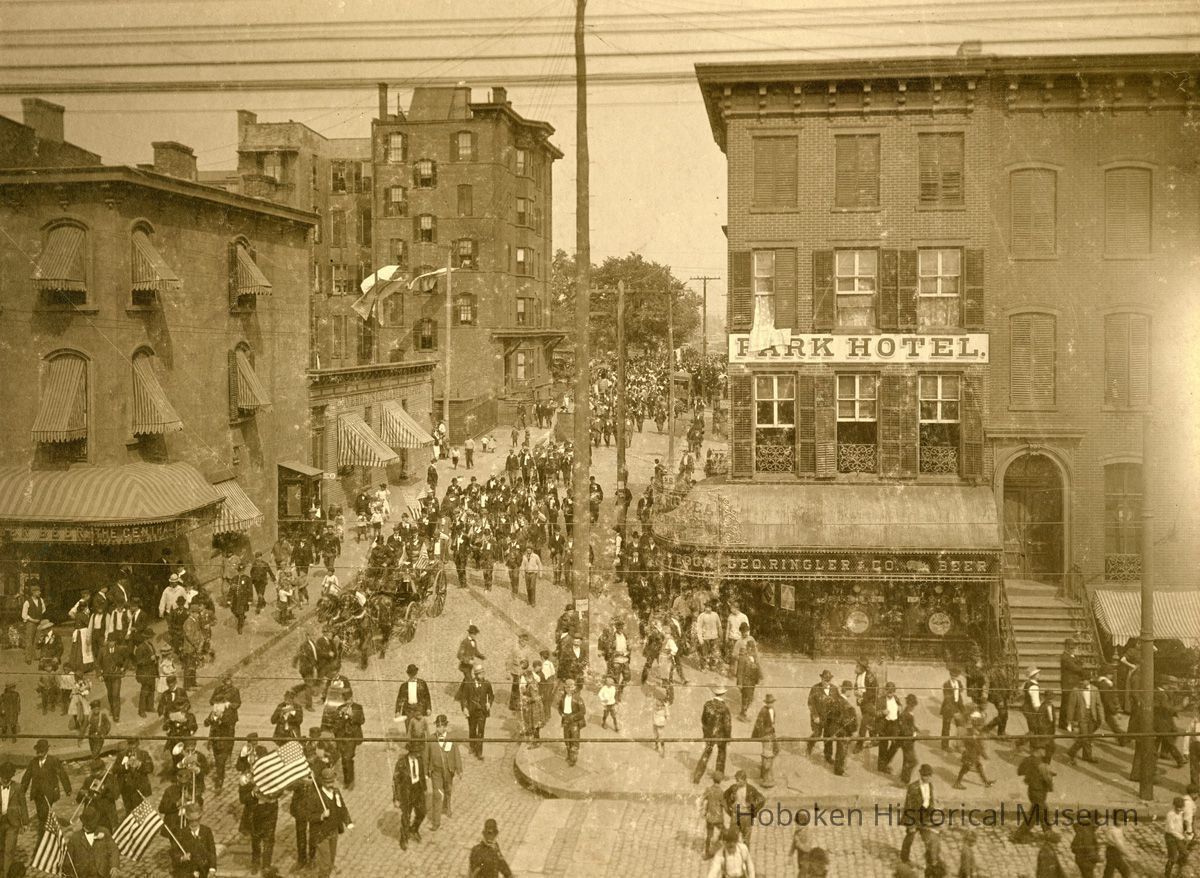 Sepia-tone photo of funeral procession at Fifth and Washington Streets, Hoboken, 1900. picture number 1