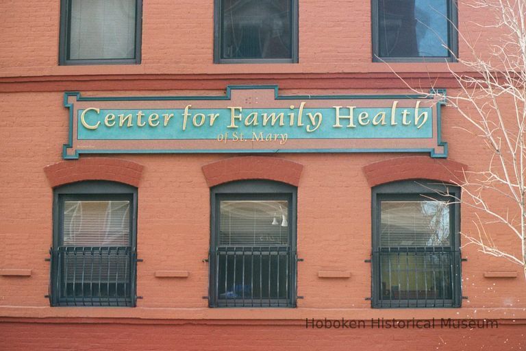 Color photo of a wall sign for Center for Family Health of St. Mary, 122-132 Clinton Street, Hoboken, Jan. 3 & 4, 2002. picture number 1