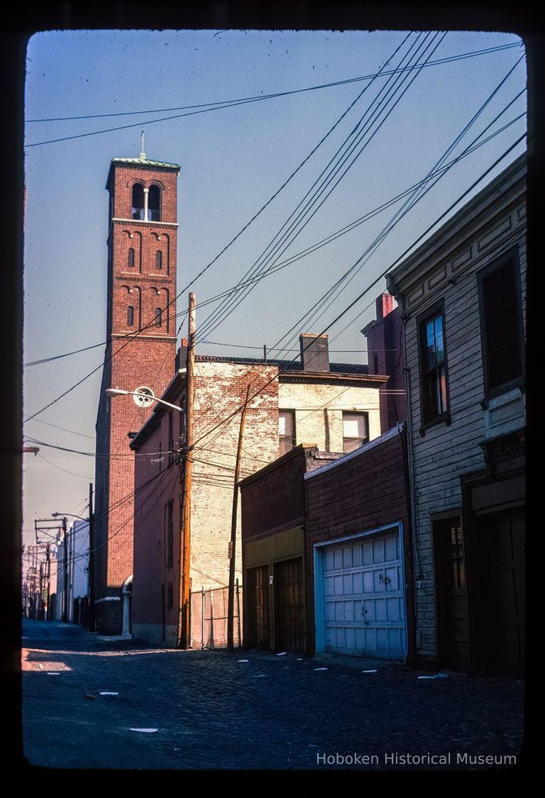 Color slide of eye-level view from Court between 3rd & 4th looking N at the bell tower of Saints Peter & Paul Catholic church picture number 1