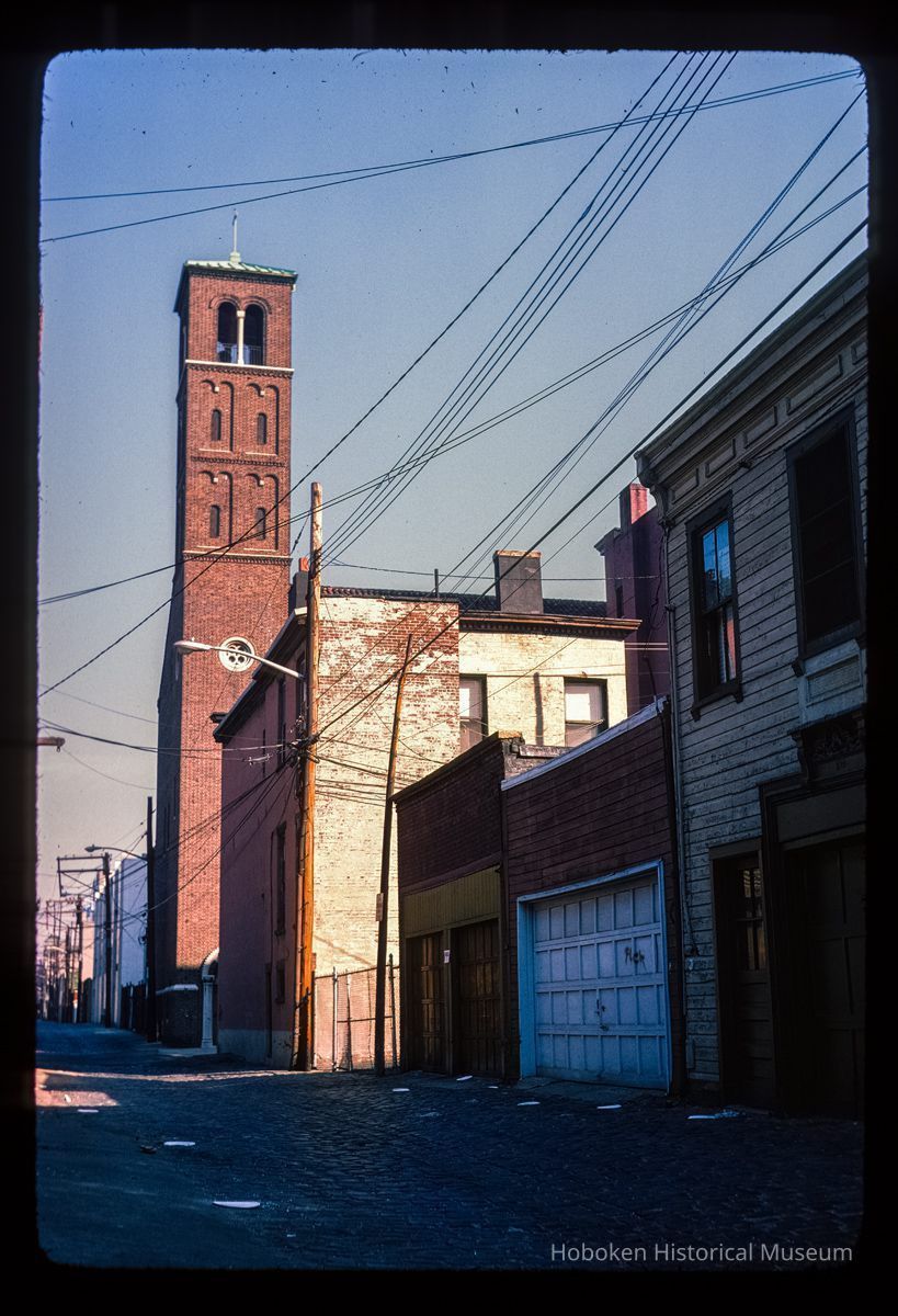 Color slide of eye-level view from Court between 3rd & 4th looking N at the bell tower of Saints Peter & Paul Catholic church picture number 1