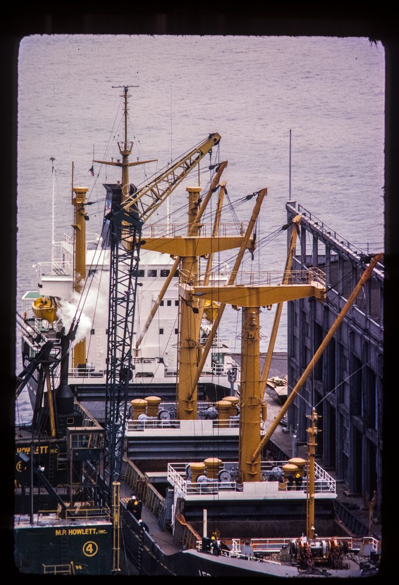 Color slide of close-up view of an unloader ship docked at Pier B on River between 2nd & 3rd picture number 1