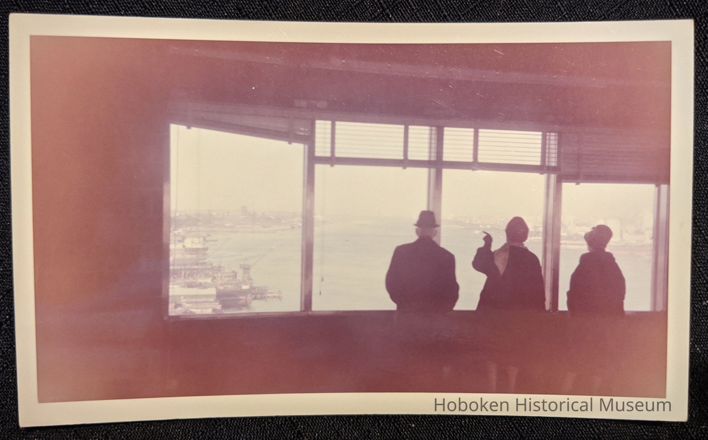 Three people looking north up the Hudson River.