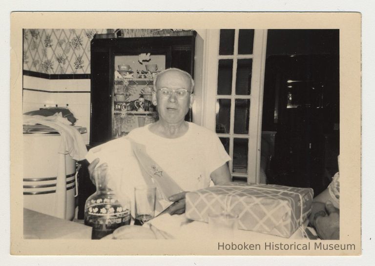 Digital image of b+w photo of Nicola Principe seated at a kitchen table, 416 Clinton St., Hoboken, n.d., ca. 1950s. picture number 1