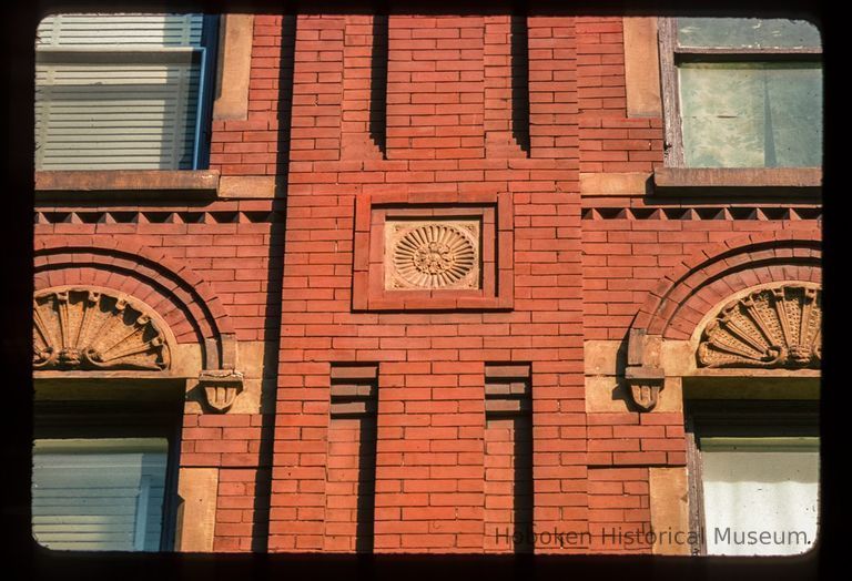 Color slide of detail view of decorative tile, brick pilasters and semicircular arches on the façade of 819 and 821 Washington between 8th and 9th picture number 1